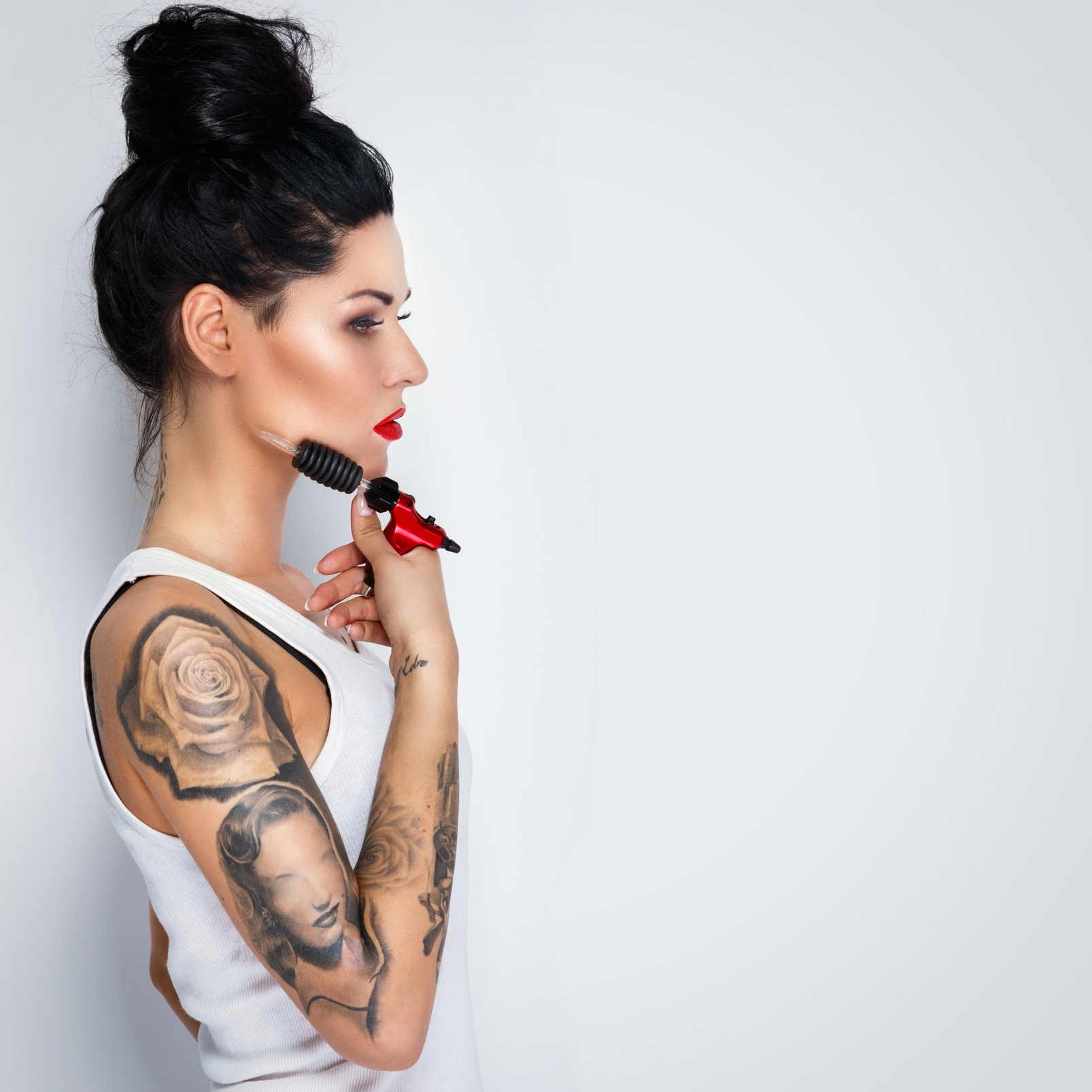 Woman Tattooist with a Tattoo-Machine in Her Hand